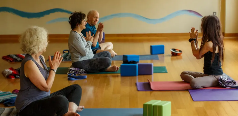Yoga class in seated prayer posture